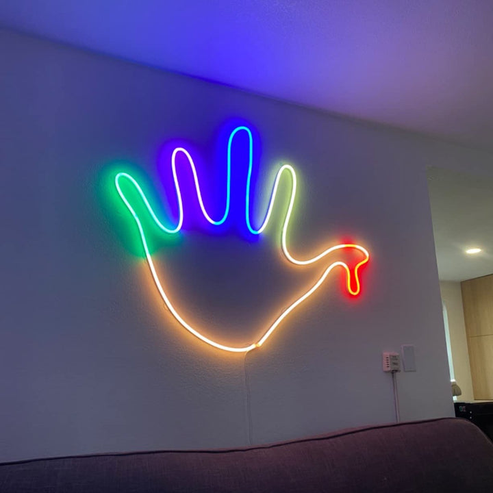 Multicolor LED Rope Light, Alexa compatible, with a hand placed on the wall next to it, showing off its vibrant, customizable lighting perfect for creating a personalized, cozy ambiance.