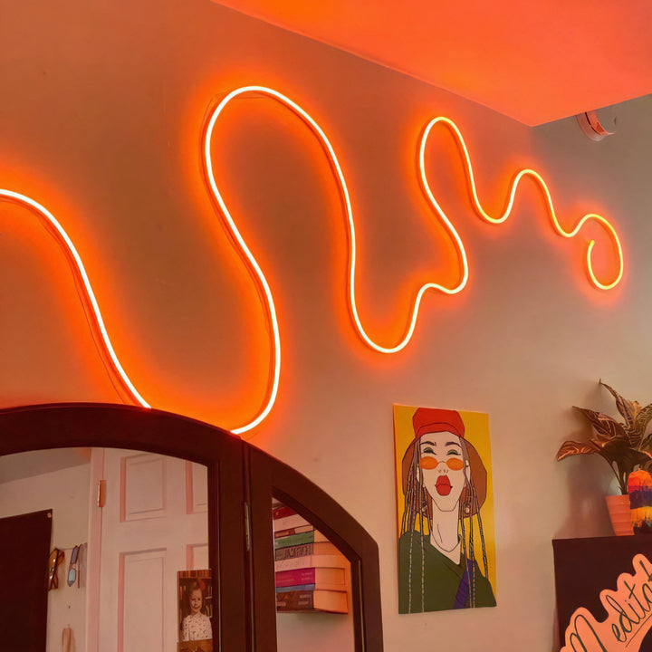 Multicolor LED Rope Light in orange, glowing in a bedroom setting, showcasing vibrant, customizable lighting perfect for creating a cozy, aesthetic atmosphere.