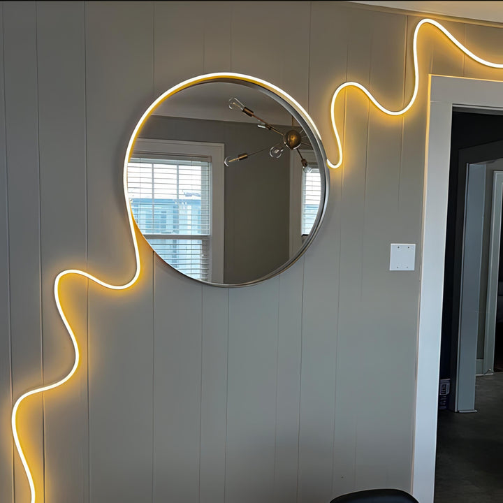Multicolor LED Rope Light, Alexa compatible, emitting a warm white glow around a mirror, creating a cozy and inviting atmosphere in the room.