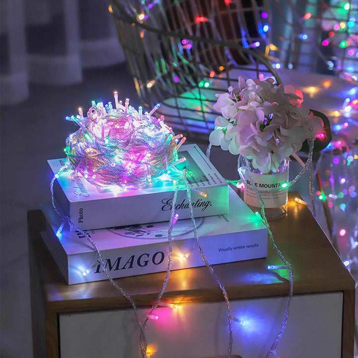VibeCore 10M colorful traditional string lights in multicolor, arranged on a table, adding a vibrant and lively glow to the space, creating a fun, cozy atmosphere.