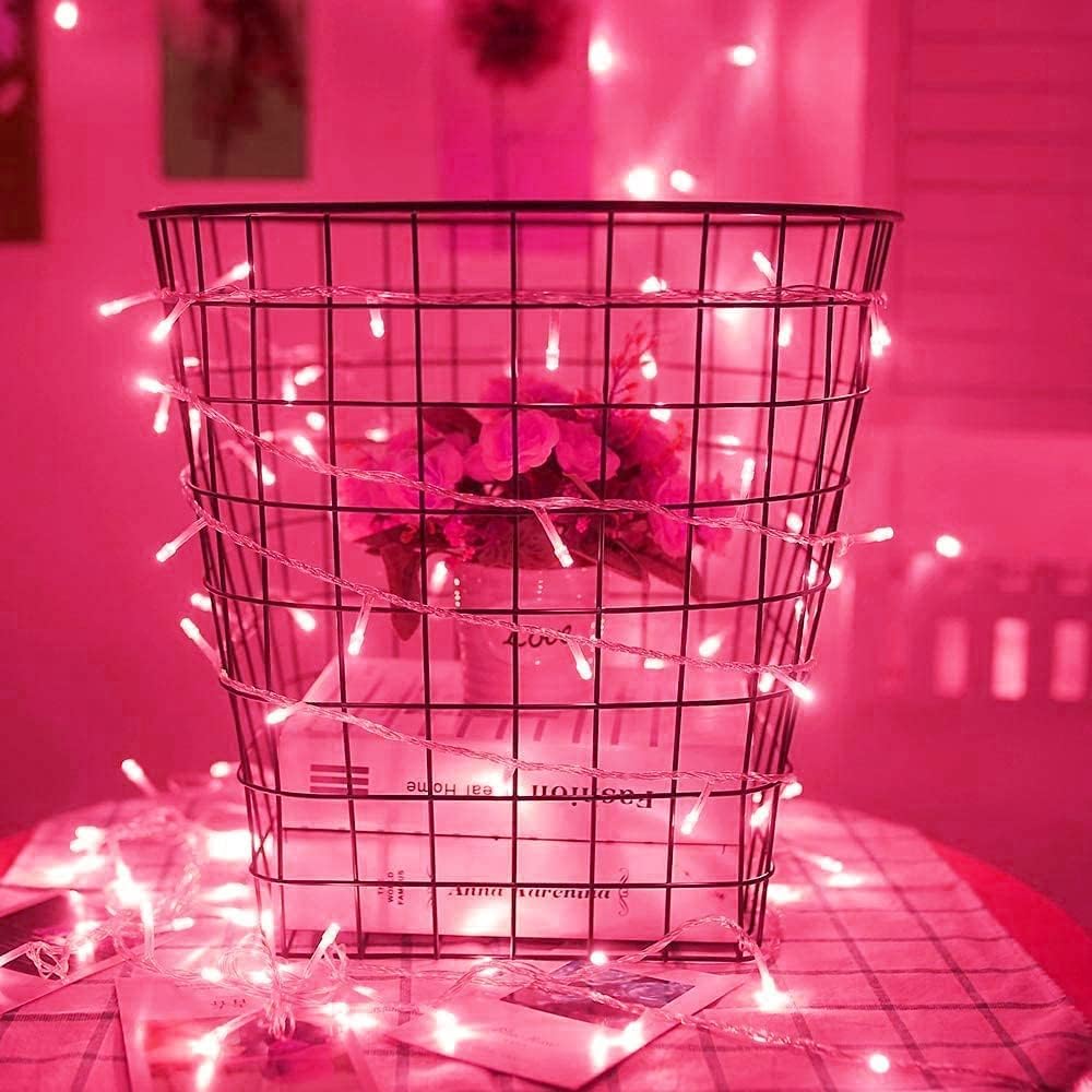 VibeCore 10M Colorful Traditional String Lights in Pink on Table, creating a soft, vibrant glow that adds a touch of warmth and playfulness to your space. Perfect for decorating your table and creating a cozy atmosphere.