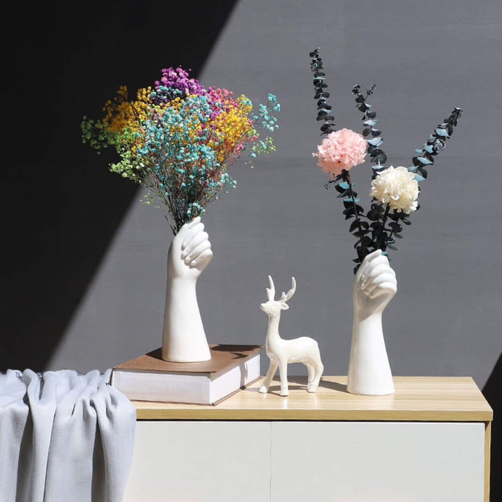 VibeCore 2 Ceramic Hand Vases holding flowers, elegant sculptural hand-shaped design in porcelain, displaying artificial flowers for timeless and minimalist decor.
