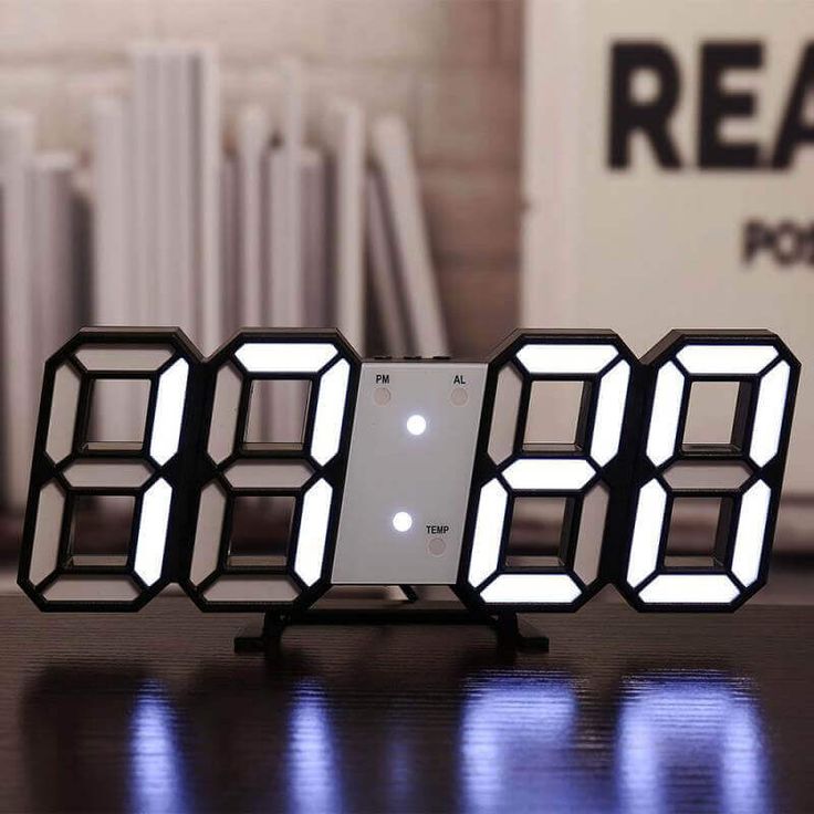 VibeCore 3D LED Digital Alarm Clock in black with white light, featuring bold, illuminated 3D LED digits for easy time readability. This modern alarm clock includes additional features like a thermometer, perpetual calendar, and moon phase display. Its sleek black design adds a contemporary and stylish touch to any room, perfect for both functionality and aesthetic appeal.