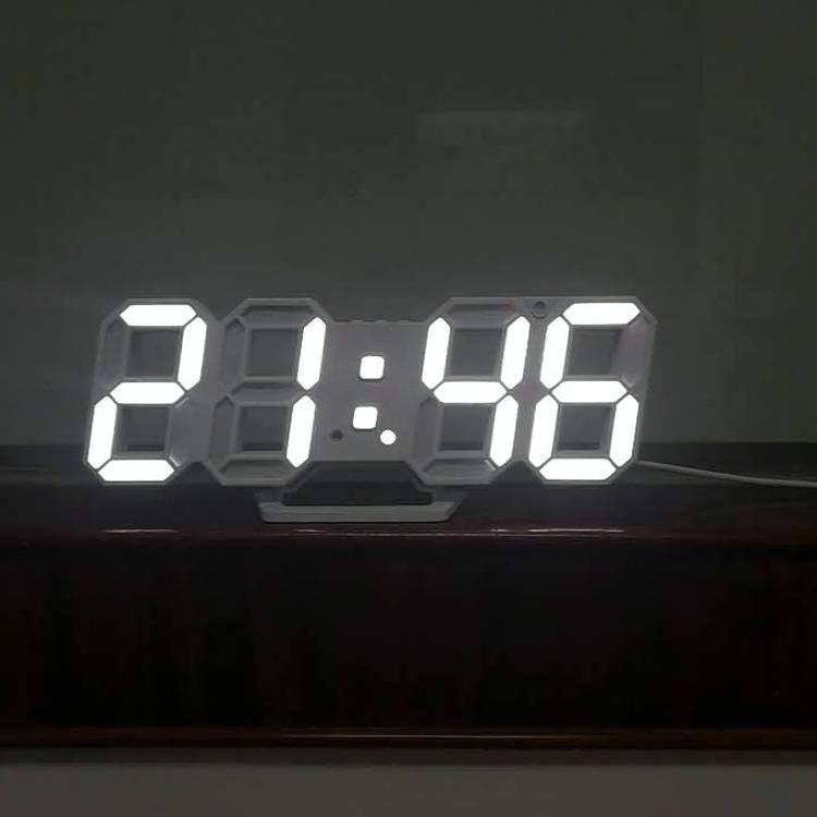 VibeCore 3D LED Digital Alarm Clock in white with white light, front view. Featuring bold, illuminated 3D LED digits for clear time display, this modern alarm clock also includes a thermometer, perpetual calendar, and moon phase display. Its sleek rectangular design adds a stylish, contemporary touch to any room.
