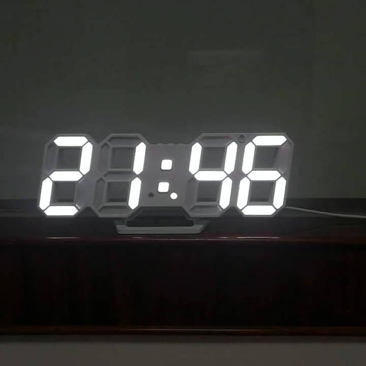 VibeCore 3D LED Digital Alarm Clock in white with white light, front view. Featuring bold, illuminated 3D LED digits for clear time display, this modern alarm clock also includes a thermometer, perpetual calendar, and moon phase display. Its sleek rectangular design adds a stylish, contemporary touch to any room.