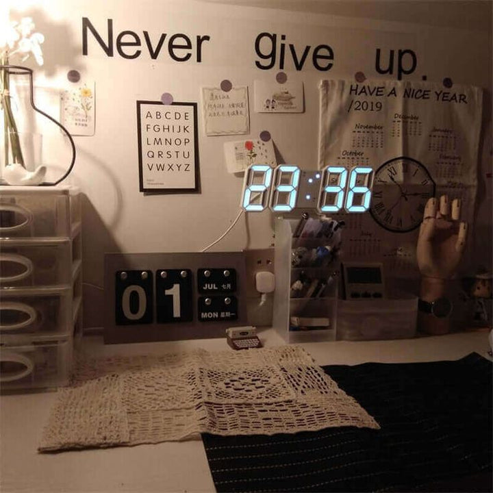 VibeCore 3D LED Digital Alarm Clock in white with white light, displayed on college desk. Featuring bold, illuminated 3D LED digits for clear time visibility, this modern alarm clock also offers a thermometer, perpetual calendar, and moon phase display. Its sleek, rectangular design adds a contemporary touch, making it the perfect functional and stylish addition to any student workspace.