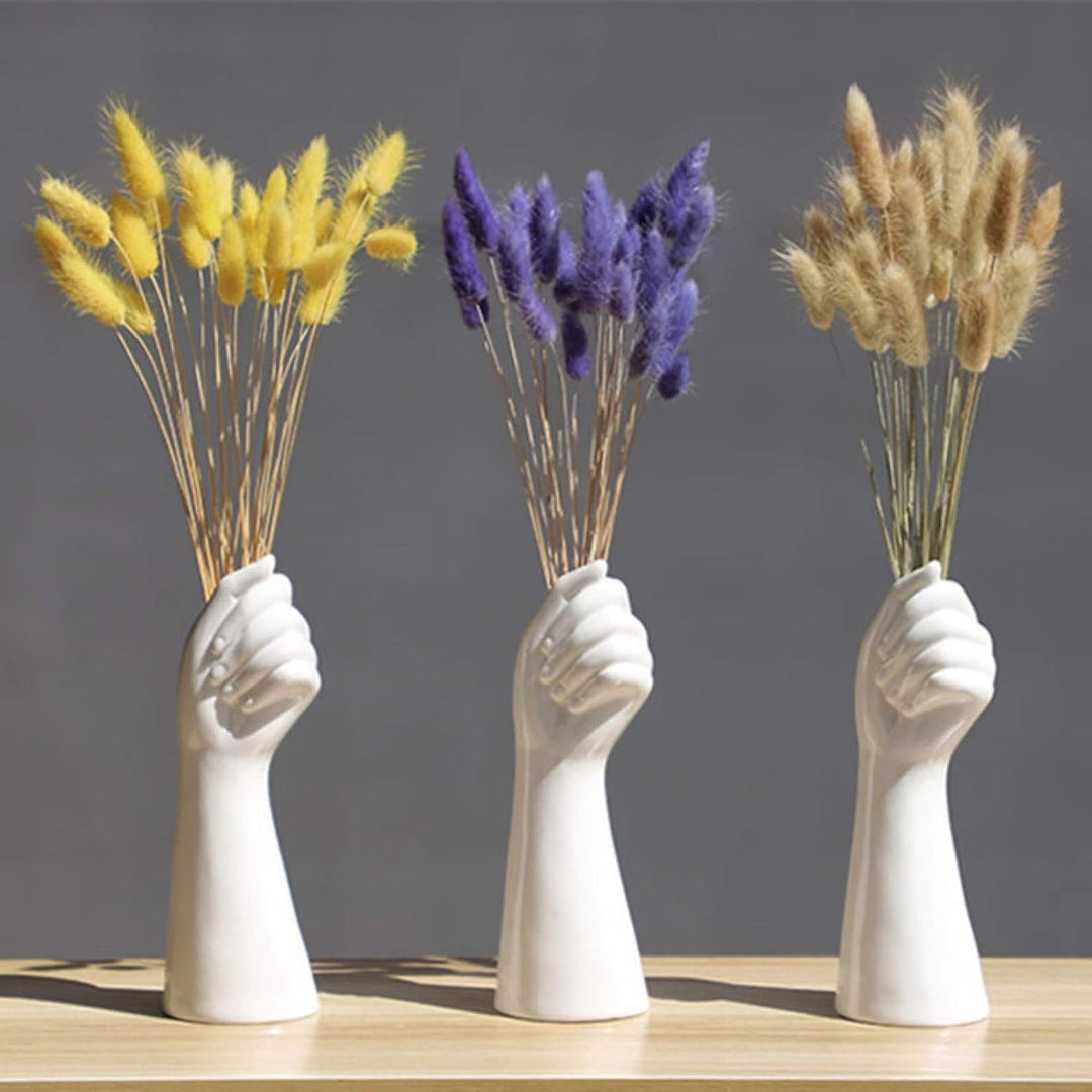 VibeCore 3 Ceramic Hand Vases holding artificial flowers, featuring elegant hand-shaped porcelain designs, each with a unique arrangement of blooms for a modern, artistic display.