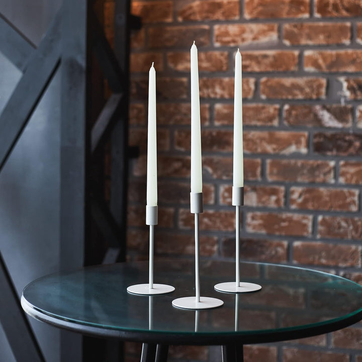VibeCore 4-Pack Scented Solid Color Long Candles White 3 in Candle Holders on Table, premium handcrafted taper candles, minimalist decor, elegant centerpiece, romantic ambiance, clean burn.