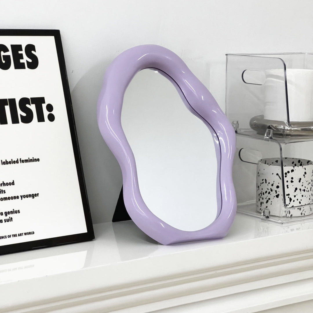 VibeCore Abstract Blob Makeup Mirror in Lilac on a dresser, adding a soft, modern touch to your space with its unique shape and pastel aesthetic.