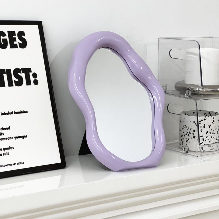 VibeCore Abstract Blob Makeup Mirror in Lilac on a dresser, adding a soft, modern touch to your space with its unique shape and pastel aesthetic.