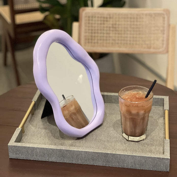 VibeCore Abstract Blob Makeup Mirror in Lilac on a table, bringing a trendy, artistic vibe to your space with its sleek design and pastel hue.