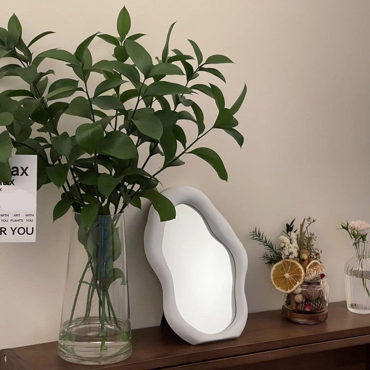 VibeCore Abstract Blob Makeup Mirror White on a console table, adding a sleek, modern touch to any space with its unique, artistic design.