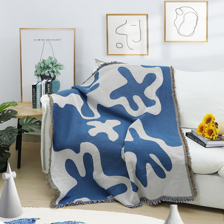 Soft Abstract Blue Coral Woven Cotton Blanket Draped on a Couch – Reversible, Artistic Throw for Cozy Living Room Decor