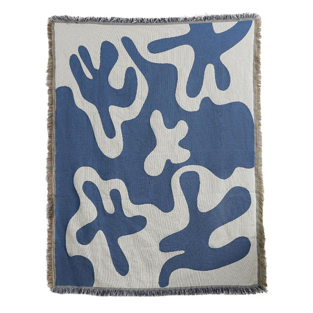 VibeCore Abstract Blue Coral Woven Blanket product view, highlighting its unique coral-inspired abstract design. Crafted from 100% combed cotton, this blanket combines comfort and artful style, perfect for adding a creative touch to your space. Its reversible patterns provide easy style versatility, making it a must-have for any room.
