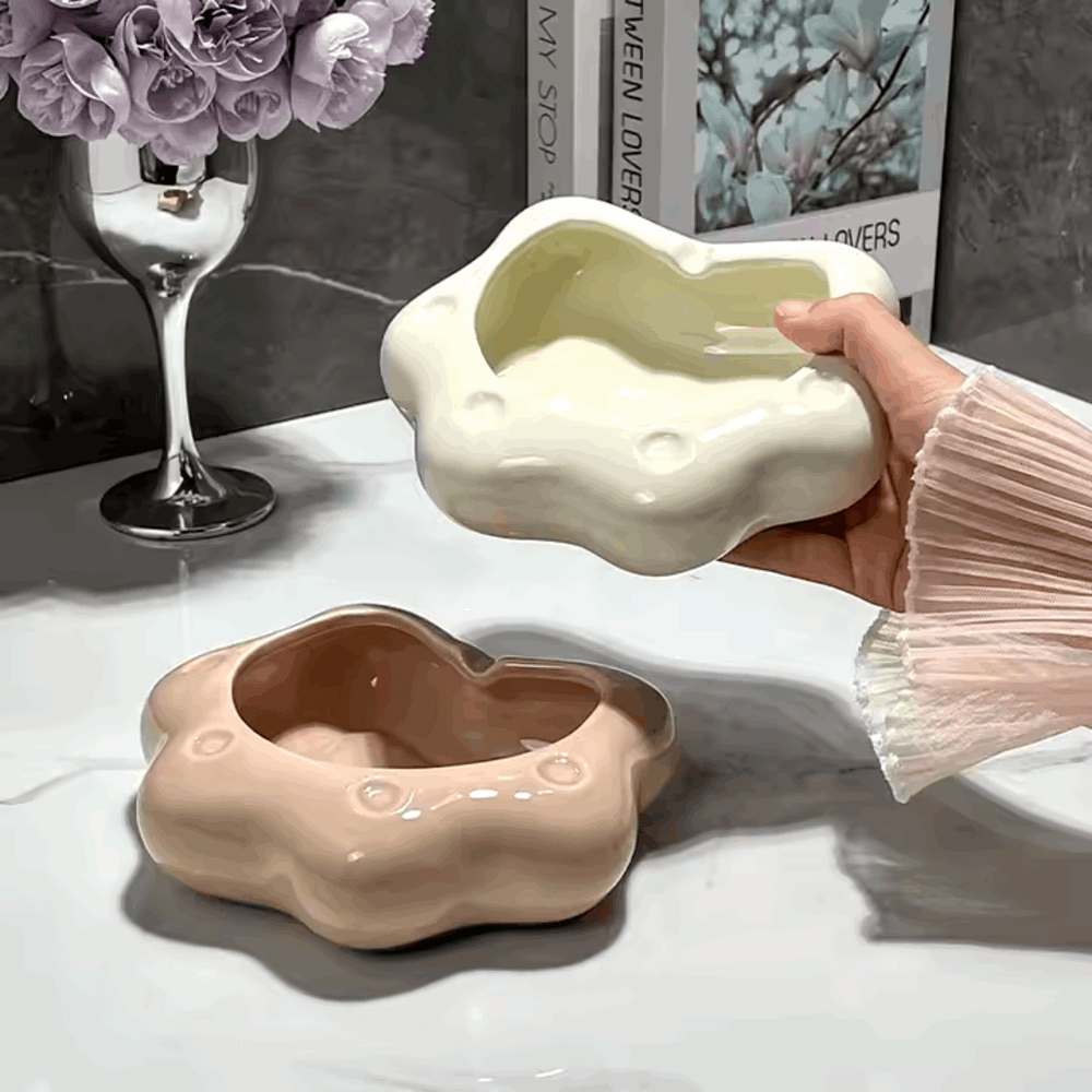 VibeCore Abstract Cloud Ashtray Rose and White being held, showcasing modern cloud-shaped designs in rose and white colors, crafted from durable ceramic, perfect for smoking or as unique decor.