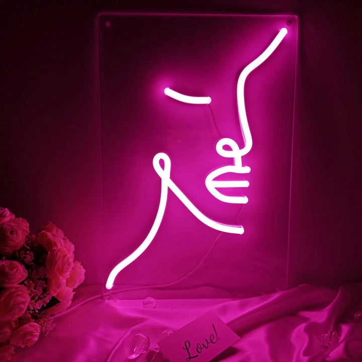 VibeCore Abstract Face Neon Light Against Wall On Table