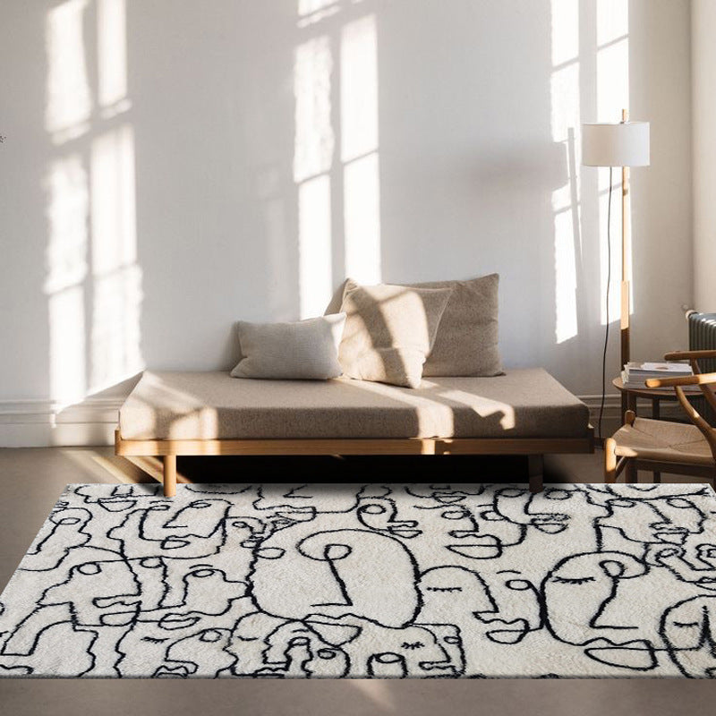 VibeCore Abstract Faces Rug in a living room, placed on a hardwood floor, adding a modern, artistic vibe with black and white abstract face illustrations.