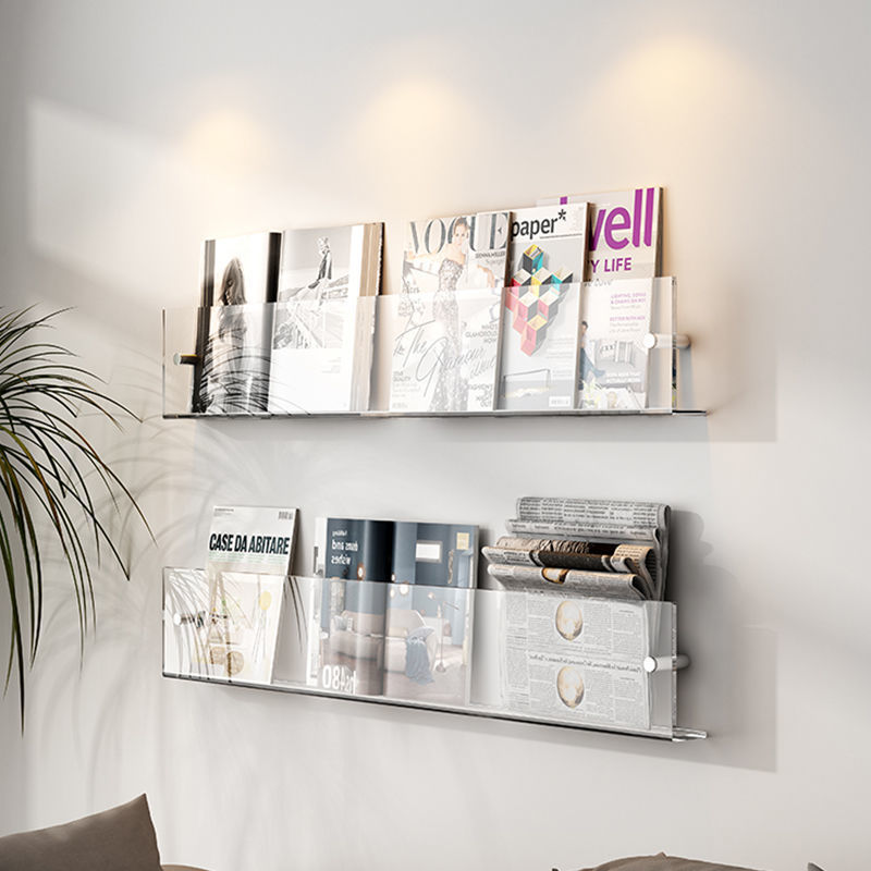 VibeCore Acrylic Wall Mounted Floating Magazine Shelf in transparent, alternative angled front view emphasizing its minimalist design and ideal for showcasing magazines, books, and decor.