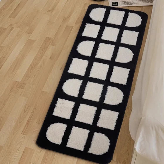 VibeCore Aesthetic Abstract Rug viewed from above, showcasing its clean lines and geometric black and white design. The rug adds a modern, minimalist touch to the space, with a plush, comfortable texture.