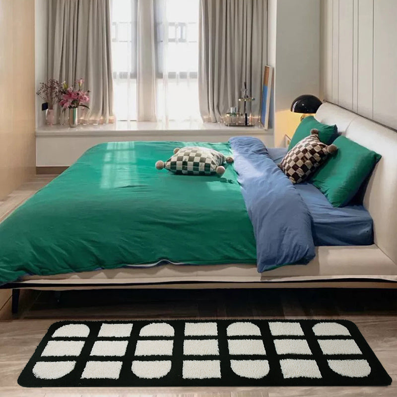 VibeCore Aesthetic Abstract Rug placed in a bedroom, featuring a minimalist black and white geometric design. The rug's soft texture and non-slip backing enhance the modern decor, making it the perfect addition to a contemporary room.