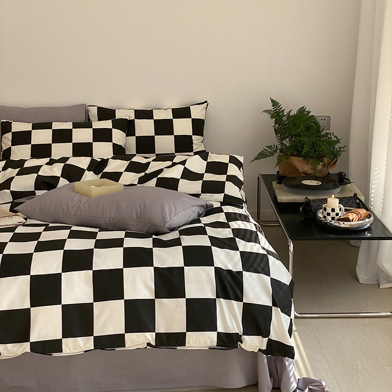 Black and white checkered duvet cover set from VibeCore Aesthetic, made from 100% ultra-soft cotton. The aerial right-side view highlights its bold, modern design that elevates any bedroom or dorm with a chic and inviting aesthetic. Includes a durable, breathable duvet cover, flat sheet, and pillowcases, perfect for all-season comfort and effortless style.