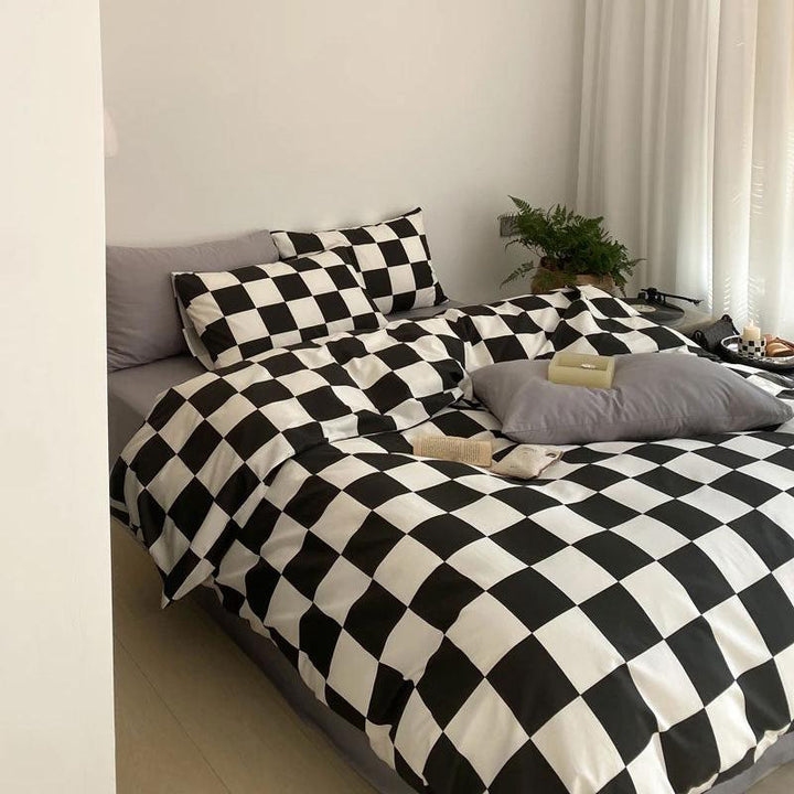 Aerial side view of the VibeCore Aesthetic Checkered Duvet Cover Set in black and white, highlighting the bold checkered pattern and the soft, breathable texture of the 100% cotton fabric. A modern and cozy addition to elevate any bedroom or dorm space.