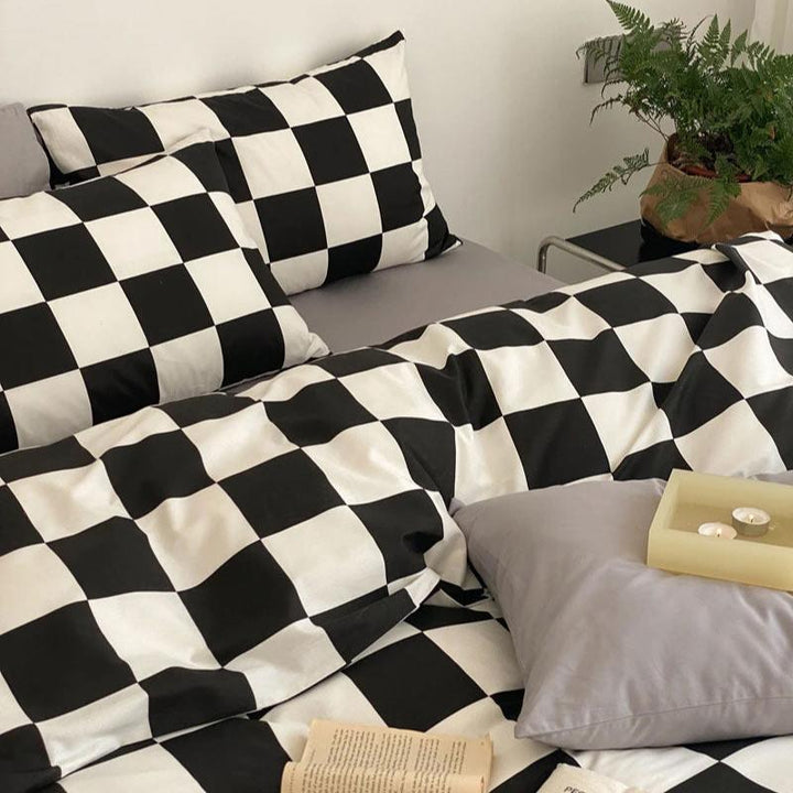 Close-up view of the VibeCore Aesthetic Checkered Duvet Cover Set in black and white, highlighting the intricate checkered pattern and ultra-soft 100% cotton fabric. A perfect blend of modern style and cozy comfort for any bedroom or dorm.