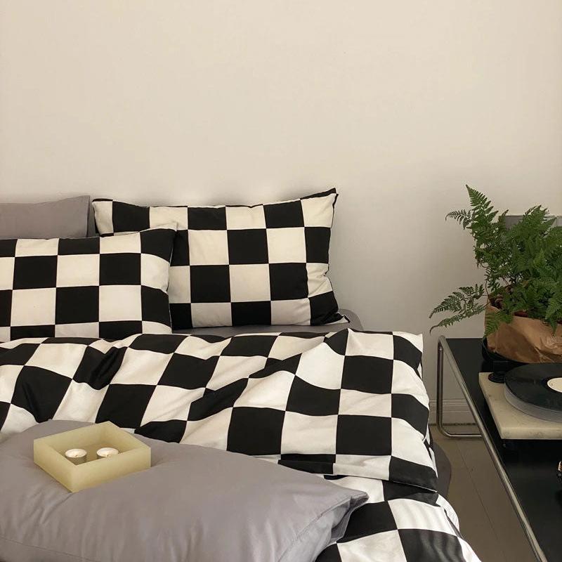 Side right view of the VibeCore Aesthetic Checkered Duvet Cover Set in black and white, highlighting its bold, modern checkered pattern. Made from 100% ultra-soft cotton, this set offers breathable comfort and sleek style, perfect for elevating any bedroom or dorm space.
