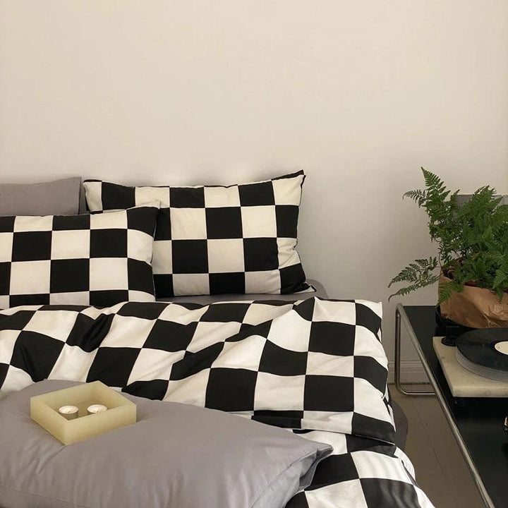 Side right view of the VibeCore Aesthetic Checkered Duvet Cover Set in black and white, highlighting its bold, modern checkered pattern. Made from 100% ultra-soft cotton, this set offers breathable comfort and sleek style, perfect for elevating any bedroom or dorm space.