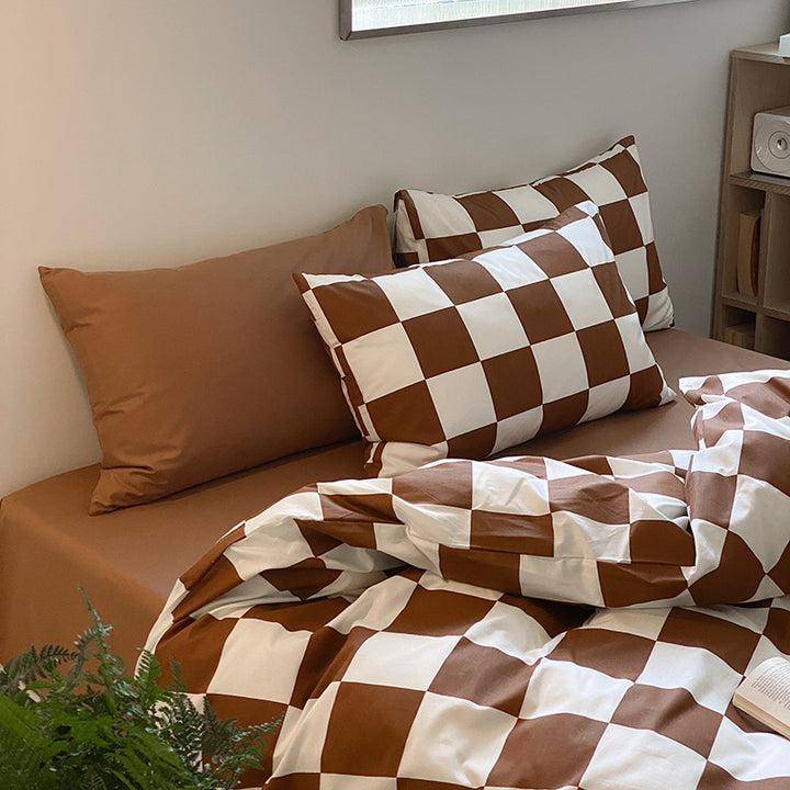 Close-up view of the pillowcase from the VibeCore Aesthetic Checkered Duvet Cover Set in brown, showcasing the bold checkered design and soft, breathable 100% cotton fabric. A stylish and cozy accent for any modern bedroom or dorm.