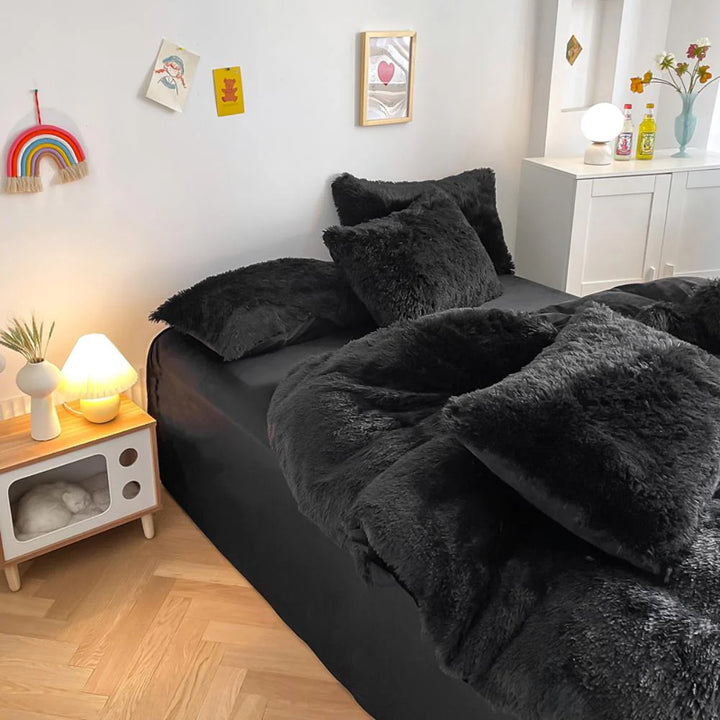 Left angle view of the VibeCore Cloud 9 Bedding Set in the color Black, featuring ultra-soft fleece fabric for unmatched comfort and warmth. This cozy bedding set adds a touch of luxury and style to your bedroom or dorm, perfect for relaxing and unwinding after a long, cold day.