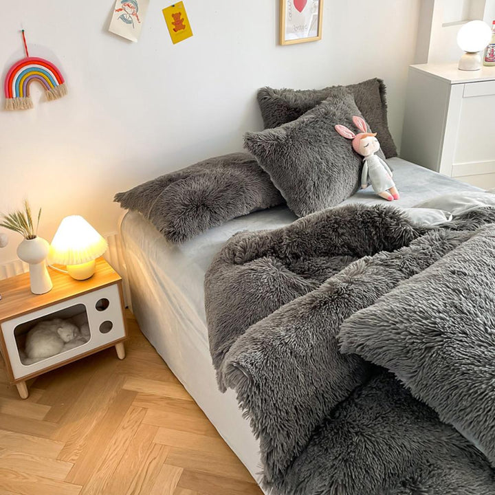 Left angle view of the VibeCore Cloud 9 Bedding Set in the color Dark Gray, featuring ultra-soft fleece fabric for unmatched comfort and warmth. This cozy bedding set adds a touch of luxury and style to your bedroom or dorm, perfect for relaxing and unwinding after a long, cold day.

