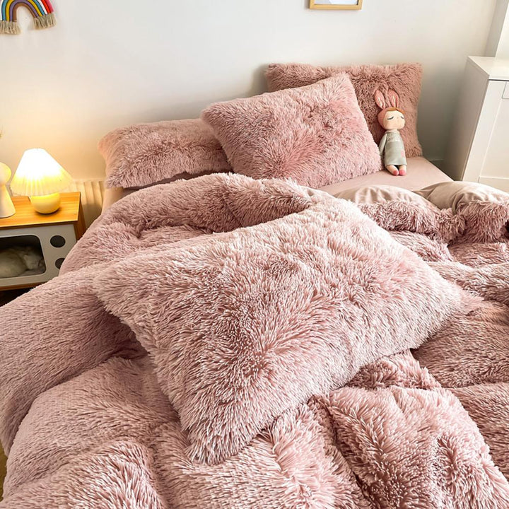 Close-up of the pillow cover and duvet from the VibeCore Cloud 9 Bedding Set in the color Rose, showcasing ultra-soft fleece fabric for exceptional comfort. This cozy, luxurious bedding set adds warmth and style to your bedroom or dorm, perfect for staying warm, relaxing, or enhancing your space.
