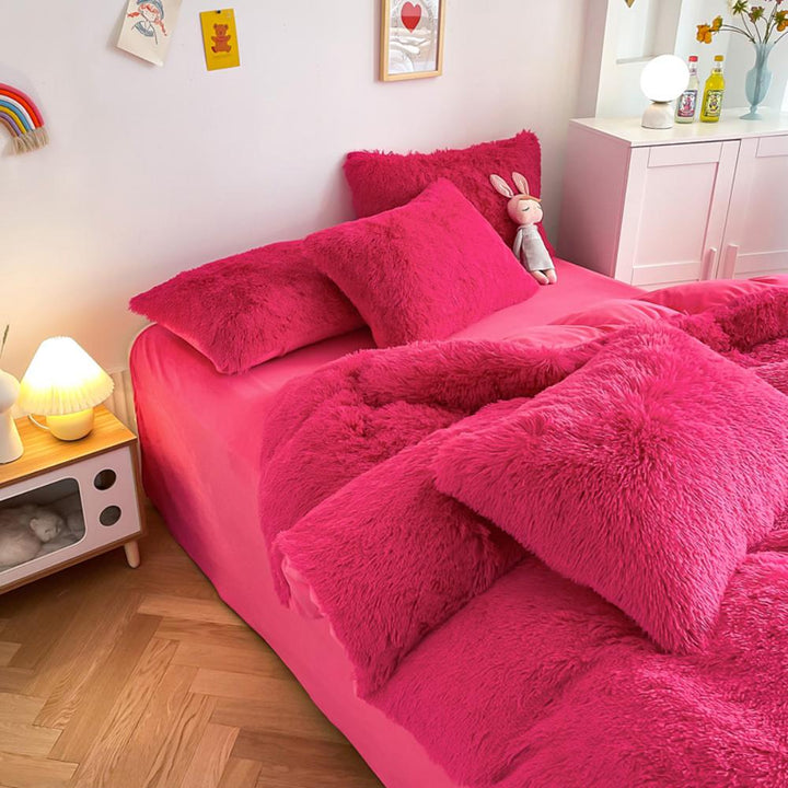 Left angle view of the VibeCore Cloud 9 Bedding Set in the color Rose Red, featuring ultra-soft fleece fabric for unmatched comfort and warmth. This cozy bedding set adds a touch of luxury and style to your bedroom or dorm, perfect for relaxing and unwinding after a long, cold day.