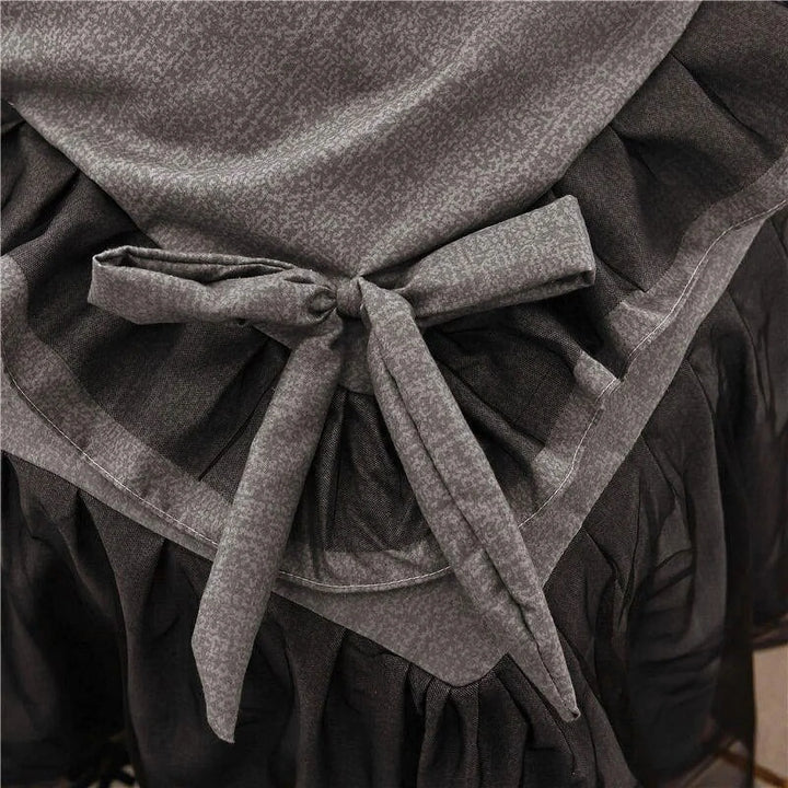 Close-up of the bow-tie feature on the duvet cover of the 'Coquette Goddess Bedding Set' in Black, showcasing its delicate, decorative detail and elegant craftsmanship. A charming touch that enhances the set's sophisticated aesthetic.