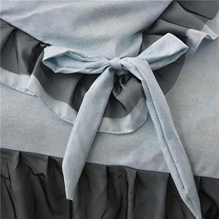 Close-up of the bow-tie feature on the duvet cover of the 'Coquette Goddess Bedding Set' in Blue Gray, showcasing its delicate, decorative detail and elegant craftsmanship. A charming touch that enhances the set's sophisticated aesthetic.