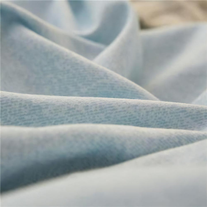 Close-up of the fabric used in the 'Coquette Goddess Bedding Set' in the color Blue Gray, highlighting its smooth, soft texture and high-quality material. The fabric exudes elegance and comfort, designed for a luxurious sleeping experience.