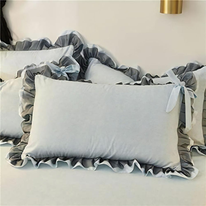 Close-up of the pillow cover from the 'Coquette Goddess Bedding Set' in the color Blue Gray, showcasing its intricate detailing, soft fabric,  elegant ruffles, and cute bow-ties. Perfect for adding a touch of coquette luxury and comfort to your bedroom or dorm.
