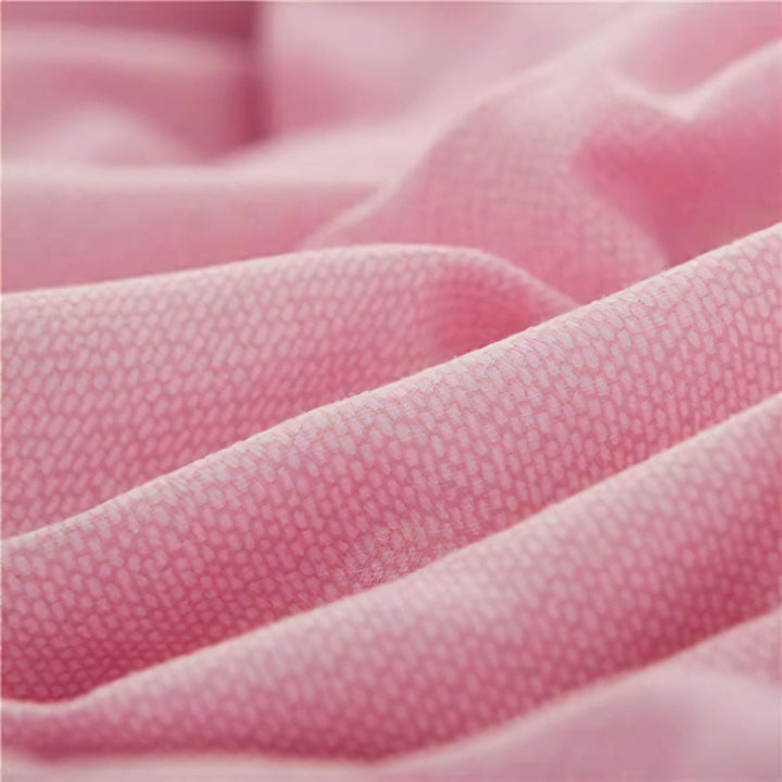 Close-up of the fabric used in the 'Coquette Goddess Bedding Set' in the color Light Pink, highlighting its smooth, soft texture and high-quality material. The fabric exudes elegance and comfort, designed for a luxurious sleeping experience.