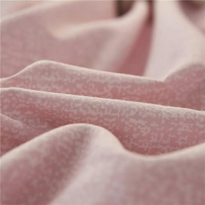 Close-up of the fabric used in the 'Coquette Goddess Bedding Set' in the color mauve, highlighting its smooth, soft texture and high-quality material. The fabric exudes elegance and comfort, designed for a luxurious sleeping experience.
