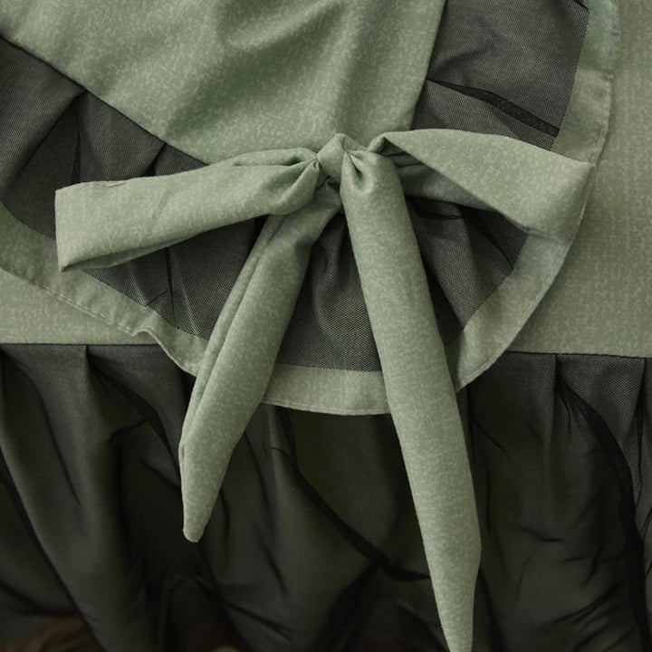 Close-up of the bow-tie feature on the duvet cover of the 'Coquette Goddess Bedding Set' in Sage, showcasing its delicate, decorative detail and elegant craftsmanship. A charming touch that enhances the set's sophisticated aesthetic.