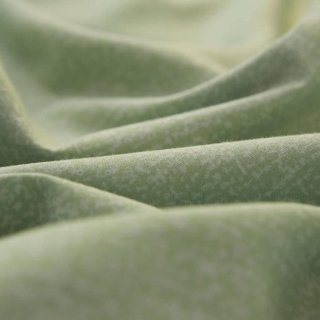 Close-up of the fabric used in the 'Coquette Goddess Bedding Set' in the color Sage, highlighting its smooth, soft texture and high-quality material. The fabric exudes elegance and comfort, designed for a luxurious sleeping experience.