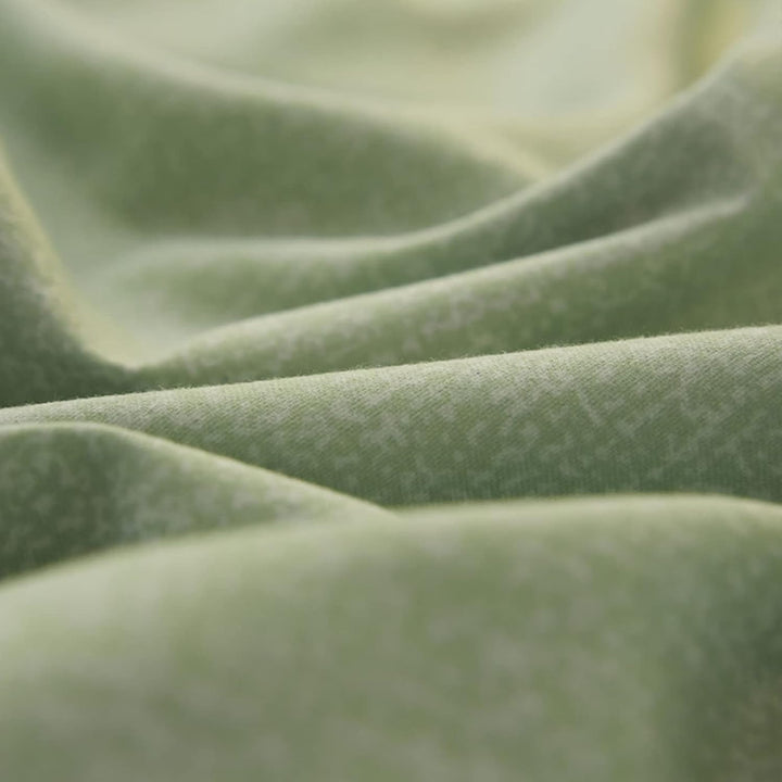Close-up of the fabric used in the 'Coquette Goddess Bedding Set' in the color Sage, highlighting its smooth, soft texture and high-quality material. The fabric exudes elegance and comfort, designed for a luxurious sleeping experience.