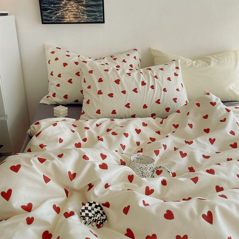 Close-up of the heart pattern on the VibeCore Crimson Love Bedding Set, showcasing the rich crimson color and soft cotton-polyester blend fabric that brings a romantic, cozy vibe to your bedroom or dorm decor.