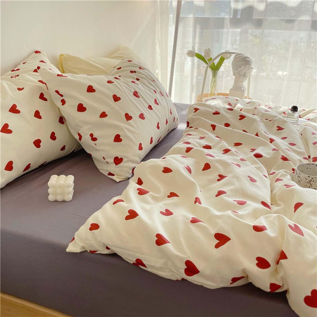 Close-up side view of the heart pattern on the VibeCore Crimson Love Bedding Set, highlighting the rich crimson color and soft, breathable cotton-polyester blend fabric.