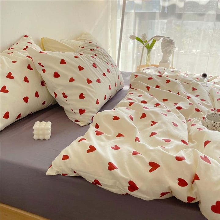 Close-up side view of the heart pattern on the VibeCore Crimson Love Bedding Set, highlighting the rich crimson color and soft, breathable cotton-polyester blend fabric.
