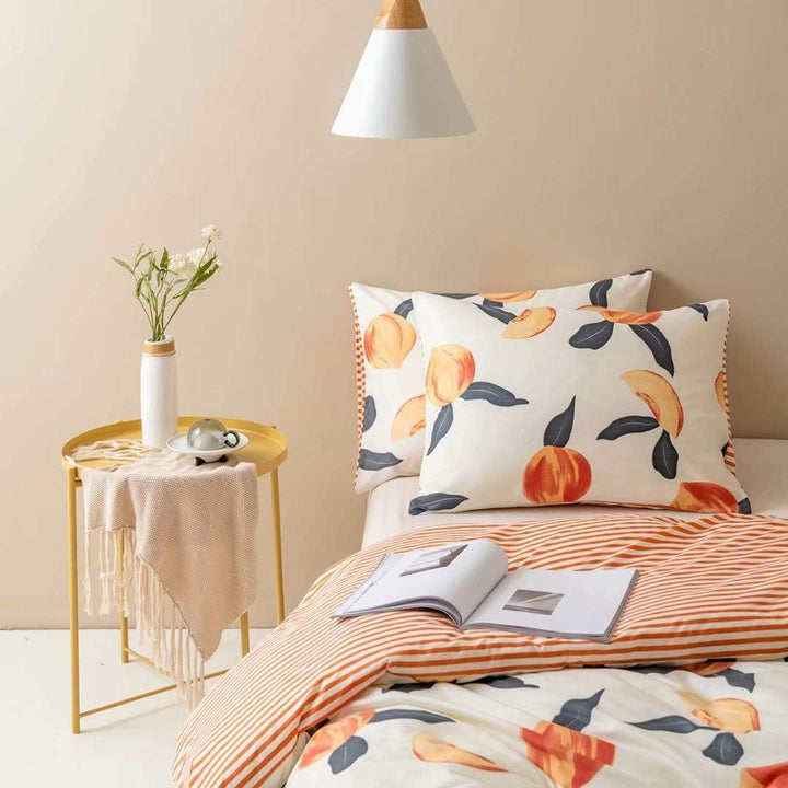 Front left view of the VibeCore Aesthetic Just Peachy Watercolor Duvet Cover Set, featuring soft watercolor peach tones in a delicate, fluid design. The cozy cotton-polyester blend offers both comfort and style, creating a warm, inviting atmosphere for any bedroom or dorm room.
