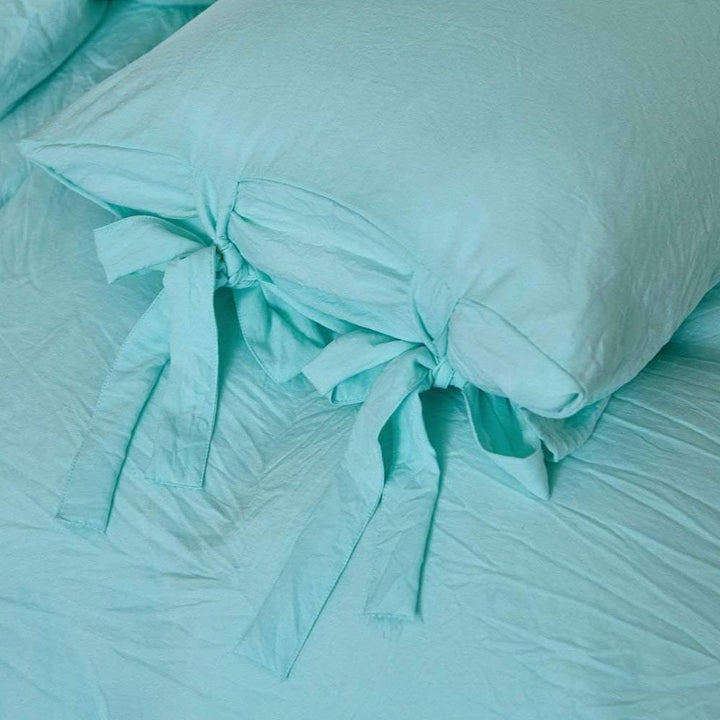 Close-up of the intricate knot detail on the aqua duvet cover from the VibeCore Aesthetic Knot So Ordinary Duvet Cover Set, highlighting the unique texture and stylish design for a cozy, chic bedroom or dorm look.