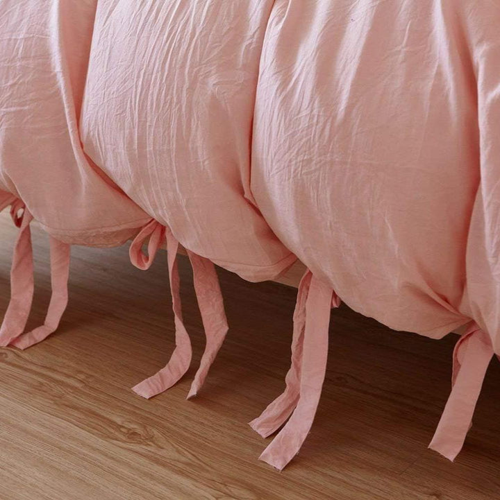 Close-up of the knot ends on the baby pink duvet cover from the VibeCore Aesthetic Knot So Ordinary Duvet Cover Set, highlighting the chic knot detail that adds a modern, stylish flair to your bedding.