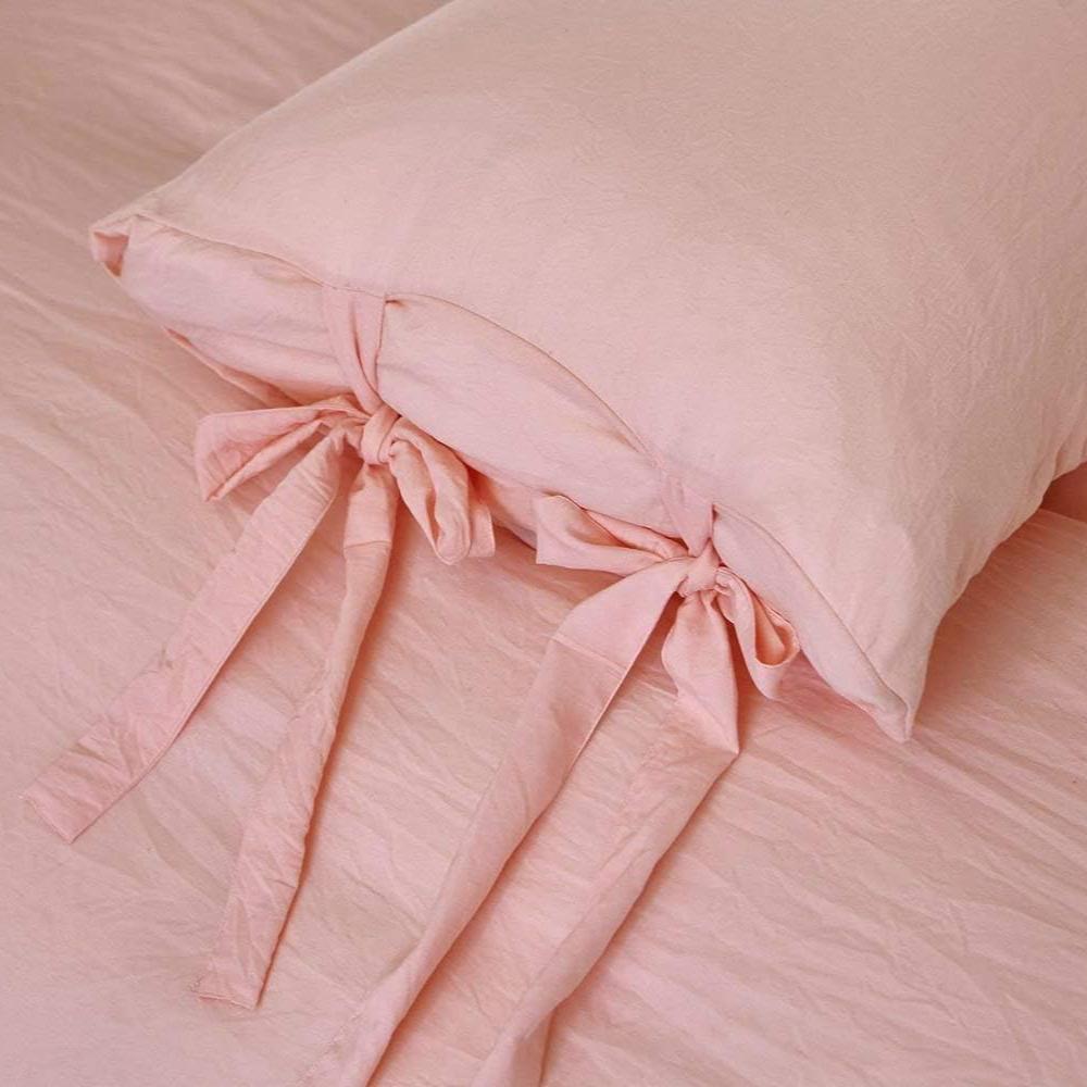 Close-up of the intricate knot detail on the baby pink duvet cover from the VibeCore Aesthetic Knot So Ordinary Duvet Cover Set, highlighting the unique texture and stylish design for a cozy, chic bedroom or dorm look.
